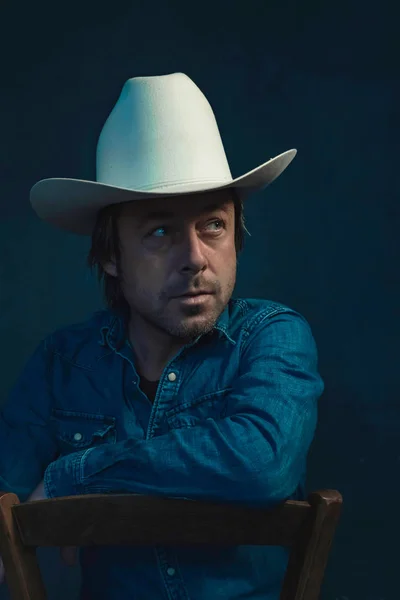 Man Wearing Denim Shirt Cowboy Hat Sits Chair — Stock Photo, Image