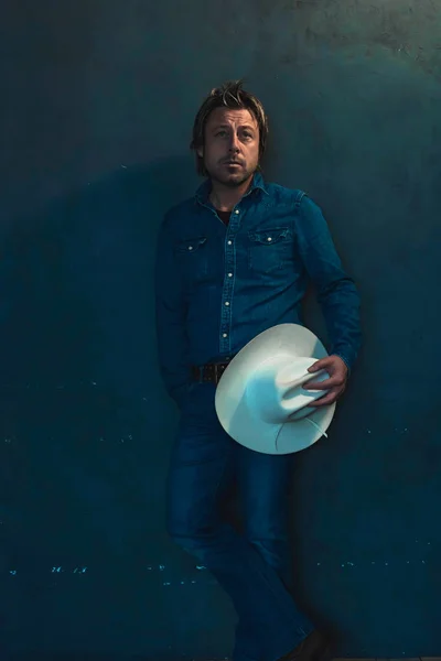 Man Wearing Denim Shirt Holding Cowboy Hat Hand Standing Wall — Stock Photo, Image