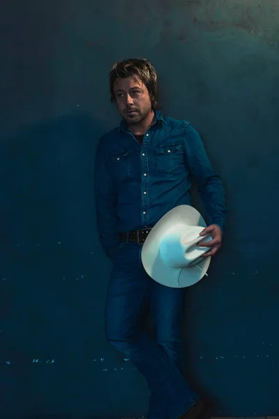 Man Wearing Denim Shirt Holding Cowboy Hat Hand Standing Wall — Stock Photo, Image