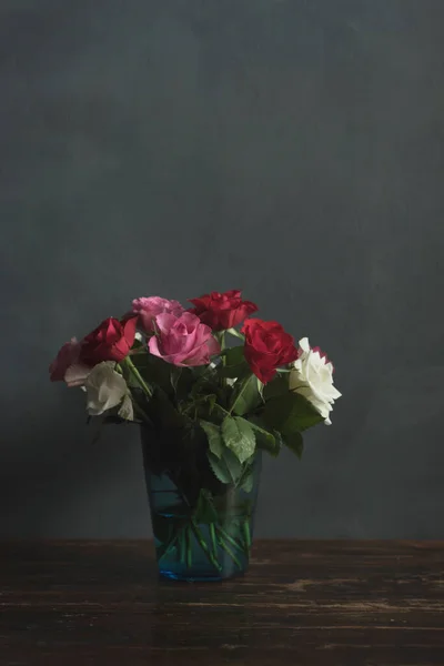 Ahşap Bir Masanın Üzerinde Kırmızı Pembe Beyaz Güller Olan Vazo — Stok fotoğraf