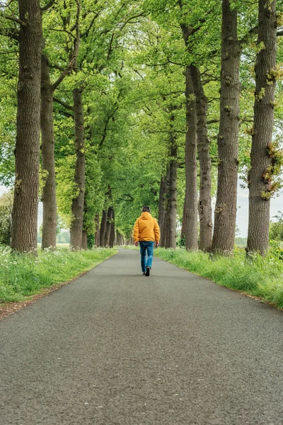 Man Yellow Jacket Jeans Walks Country Road Springtime — Stock Photo, Image