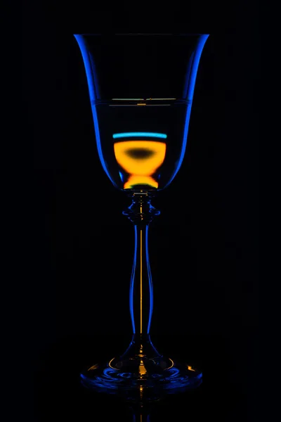 Sziluett pohár ital mellett a bárban, a fekete háttér — Stock Fotó