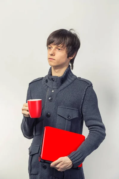 Casual happy teenager with laptop and cup — Stock Photo, Image