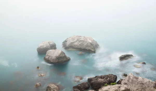 Zeegezicht met rotsen en mist — Stockfoto