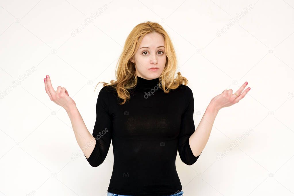 Portrait of a beautiful blonde girl on a white background showing misunderstanding.