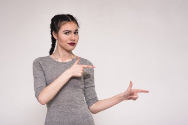 Eller yana gösterilen beyaz zemin üzerine güzel bir esmer kız portresi.