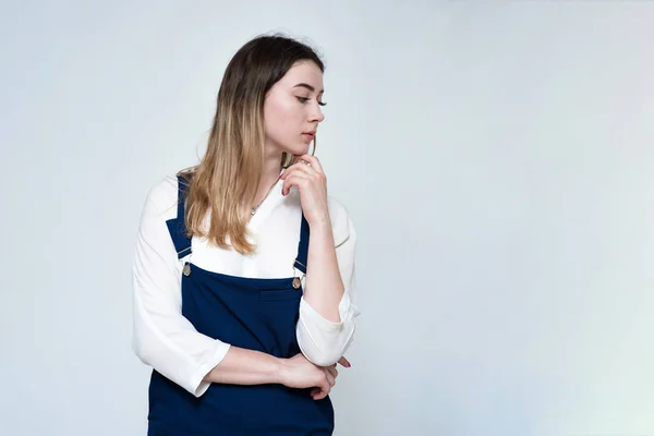 Portrait of a beautiful and young girl on a white background showing disbelief.