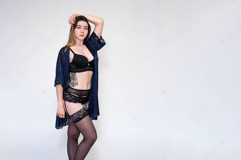 Portrait of a beautiful girl on a white background in lingerie.