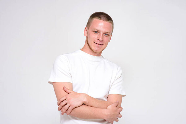 you will succeed and will be ok. Portrait of a confident young handsome man on a white background. He stands directly in front of the camera and smiles