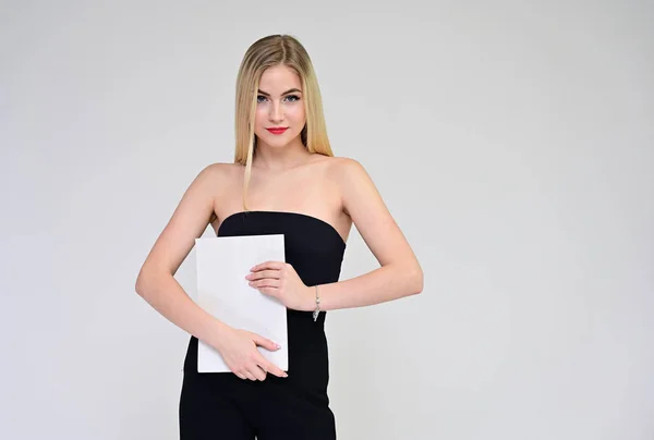 Business training concept with a girl. Portrait of a fashionable beautiful blonde model with long hair, excellent makeup, on a white background with a folder in her hands. — ストック写真