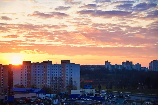 Il concetto di tramonto nel cielo serale sulla città. Foto del sole di sera sulle case in una zona moderna . — Foto Stock