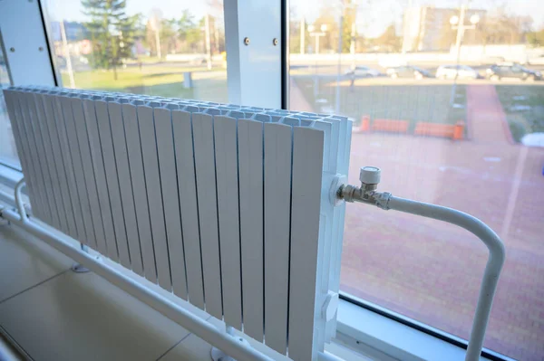 Photo of a white heating battery in a building — Stock Photo, Image