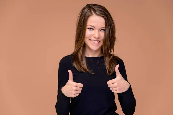 Concepto de una joven con una sonrisa de dientes blancos. Close-up Retrato de una linda chica en una camiseta negra con hermosos dientes. Sonriendo, mostrando emociones sobre un fondo rosado . — Foto de Stock