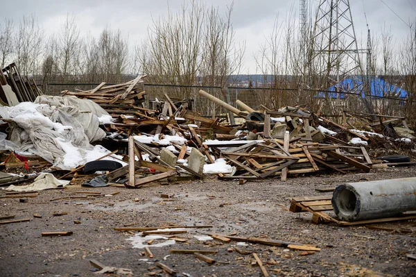 The concept of trash environmental disaster. Photo of a landfill on a street in a city on a cloudy day.