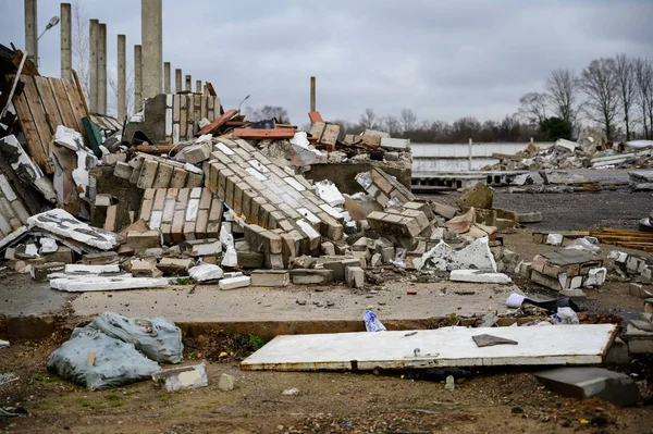 The concept of trash environmental disaster. Photo of a landfill on a street in a city on a cloudy day.