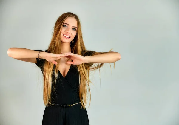 The model stands in different poses in front of the camera. The concept of fashion and style. Portrait of a pretty blonde girl with long hair and great makeup on a white background. — Stok fotoğraf