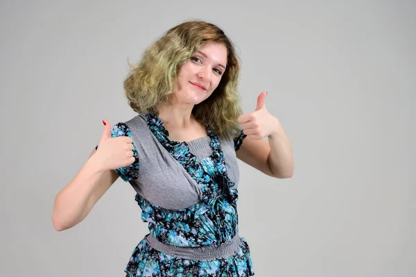 Concepto de foto horizontal de una mujer joven con emociones en un vestido de color turquesa de pie delante de la cámara sobre un fondo blanco. Retrato de una estudiante con hermoso cabello magnífico . —  Fotos de Stock