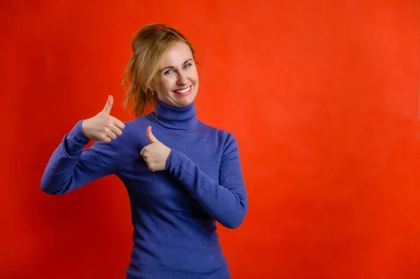 Portrait Happy Smiling Blond Woman Blue Sweater Red Background Shows — Stock Photo, Image