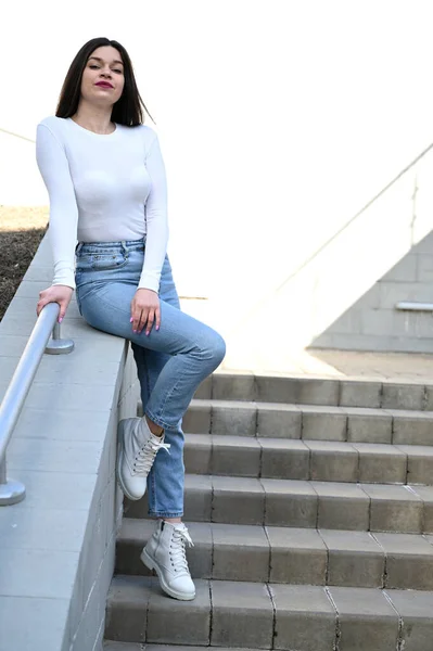 Foto Una Chica Morena Caucásica Blusa Blanca Jeans Azules Las —  Fotos de Stock