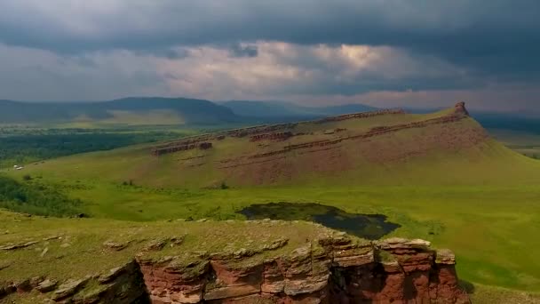 Aerial view of the mountain range Sunduki, green fields sky before the storm in the Republic of Khakassia. Russia — Stock Video