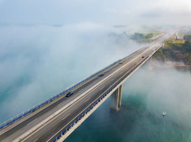 Aerial view on dos Santos bridge during fog and bay. Near Ribadeo in Northern Spain clipart