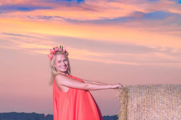 Sexy woman on hay stack on sunset. — Stock Photo, Image