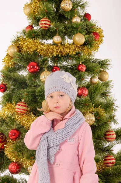 Little cute girl posing near christmas tree — Stock Photo, Image