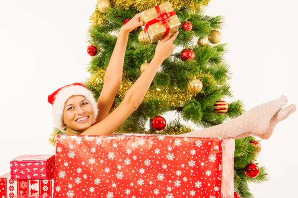 Beautiful woman posing in gift box near christmas tree — Stock Photo, Image