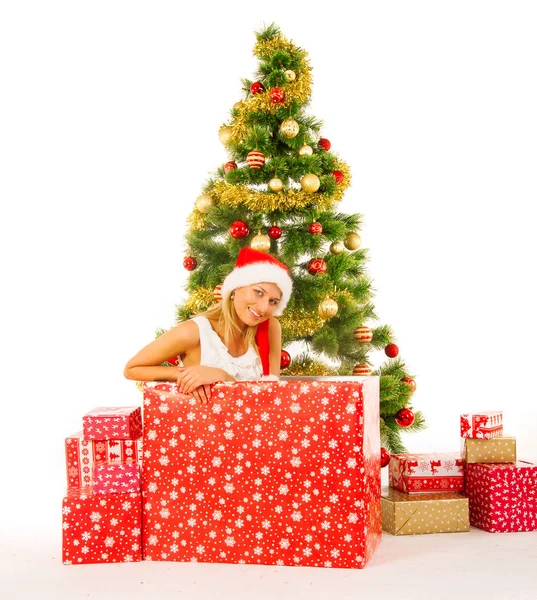 Beautiful woman posing in gift box near christmas tree — Stock Photo, Image