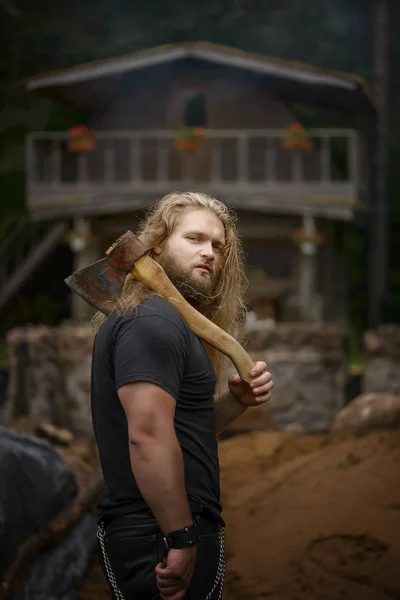 Uzun saçlı acımasız adam orman house yakınındaki eksenli — Stok fotoğraf