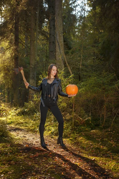 Beauty with ax and pumpkin in a forest — Stock Photo, Image