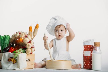 Büyük bir sepet sebzeli küçük bir çocuk.