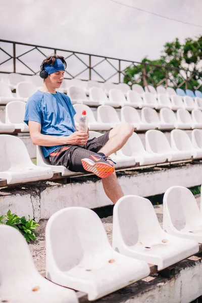 Athlete rests after running sitting on the podium
