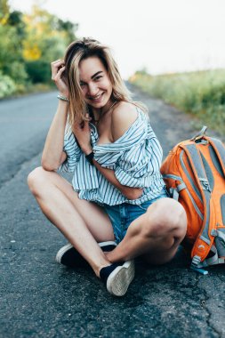 Pistte erkek gömleğiyle otostop yapan güzel kız.