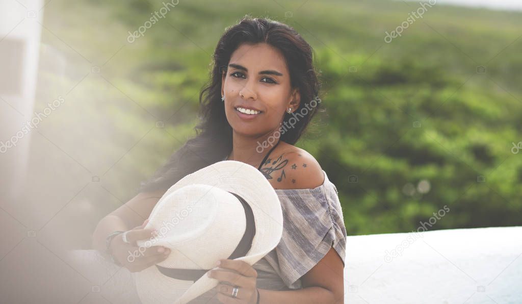 Young Mexican Woman, Outside. Beautiful Mixed Race Girl is posing outdoor with Hat.