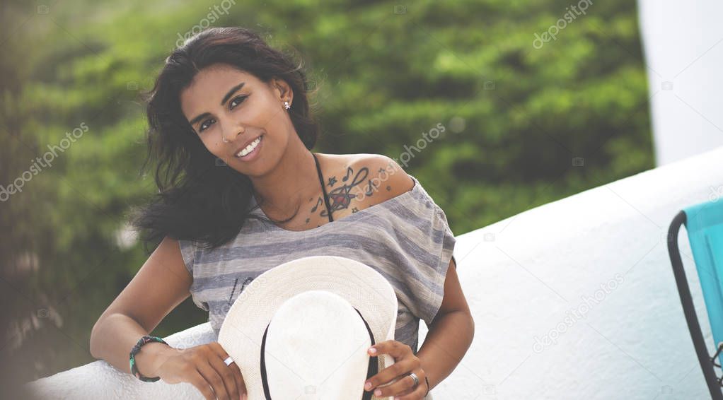 Young Mexican Woman, Outside. Beautiful Mixed Race Girl is posing outdoor with Hat.