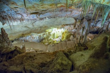 İspanya 'da Mallorca adasındaki Stalactite aydınlatmalı mağaralar. Mağaraların çok renkli aydınlatması. Güzel mağara. Eski mağaradaki sarkıtlar. Kırmızı, yeşil, mavi, mor, sarı