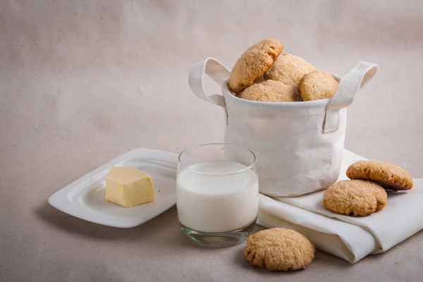 homemade biscuits in a linen basket on a beige background. cracked cookies