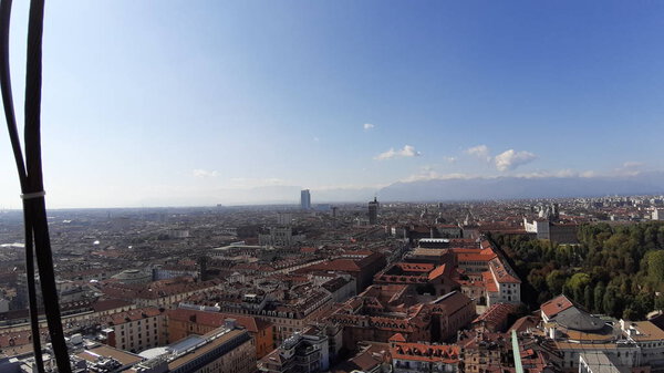 Turin, Italy - 01/004/2019: Beautiful panoramic view from Mole Antoneliana to the city of Turin in winter days with clear blue sky and the alps in the background.