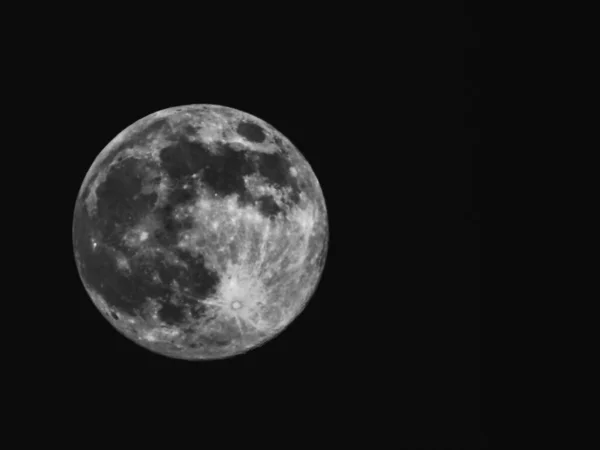 Edited version of the full moon with black sky in the background.