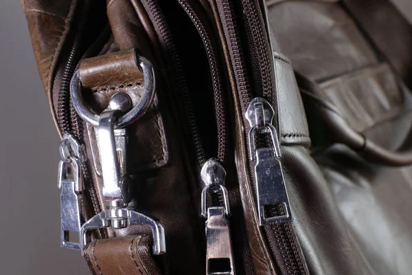 Opened zippers on a leather men\'s bag. Close up.