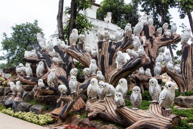 birds, owls, figures in garden clipart