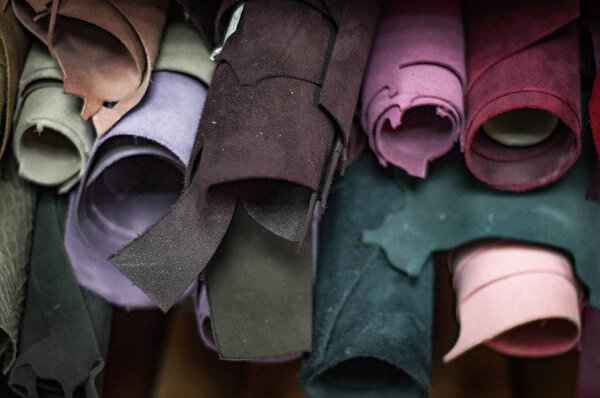 Close up of colorful textile rolls placed on shelves in fabric shop