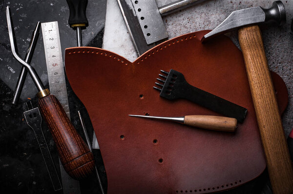 Leather crafting tools on table, manufacturing small business of shoemaker