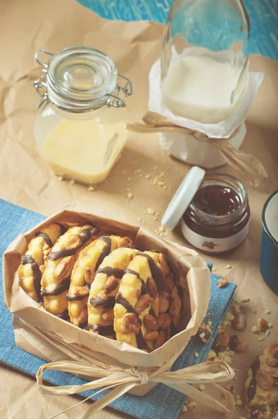 Cookie with peanuts and chocolate icing, glass jars and jam — Stock Photo, Image