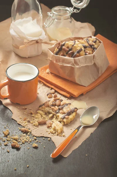 Peanut cookies and orange cup of milk — Stock Photo, Image