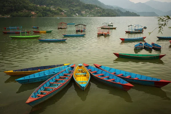 Kolorowe łodzie nad jeziorem, w mieście Pokhara, z tyłu piękny zachód słońca — Zdjęcie stockowe