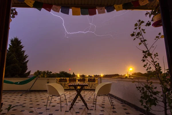 Thunder storm over a house terase in the middle of the night wit