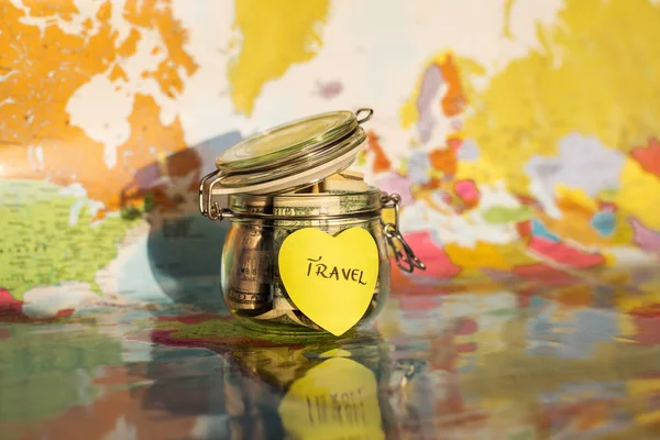旅行在一个玻璃瓶中与地图背景和 h 的钱储蓄 — 图库照片