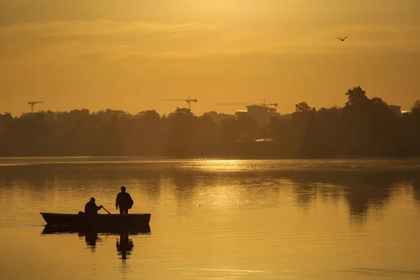 Fishermen fishing on a lake at sunrise — Stock Photo, Image